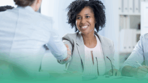 Smiling business professional shaking hands during a hiring meeting in Canada, representing employer service models such as PEO, EOR, and staffing agencies.