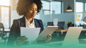 Employer reviewing employment contracts and legal documents in a modern office setting.