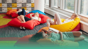 Employees resting on colourful beanbags, representing modern workplace wellness and flexible employee benefits.