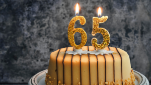 Birthday cake with gold number 65 candles symbolizing older Canadians working beyond retirement age and the growing senior workforce in Canada