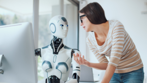Manager consulting with AI robot at computer about workplace performance decisions