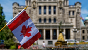 Canadian flag displayed in front of a government building, representing proposed federal labour law reforms under Bill C-39 and changes to the Canada Labour Code.